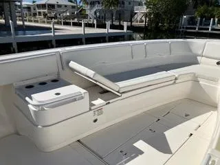 Slide: The Image of 2016 Intrepid 400 Center Console boat with spacious seating and storage, docked at a marina. - 21