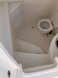 Slide: The Image of 2016 Intrepid 400 Center Console boat bathroom interior with toilet. - 22
