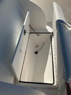 Slide: The Image of Open storage compartment on a 2016 Intrepid 400 Center Console boat. - 23