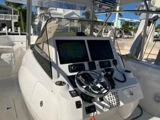 Slide: The Image of 2016 Intrepid 400 Center Console boat cockpit with modern navigation equipment. - 25