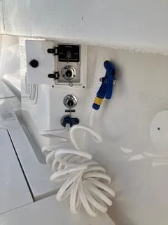 Slide: The Image of 2016 Intrepid 400 Center Console boat deck with coiled hose and control panel. - 26
