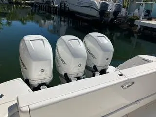 Slide: The Image of 2016 Intrepid 400 Center Console with triple Mercury outboard engines docked by the water. - 27