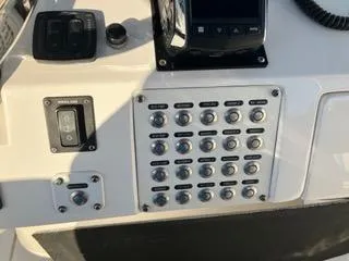 Slide: The Image of Control panel of a 2016 Intrepid 400 Center Console boat with multiple switches. - 4
