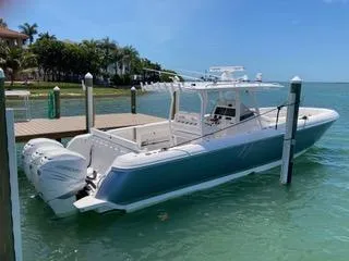 Slide: The Image of 2019 Intrepid 400 Center Console boat docked in clear blue water. - 0