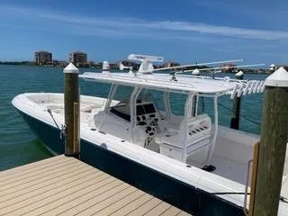Slide: The Image of 2019 Intrepid 400 Center Console boat docked by the water. - 1