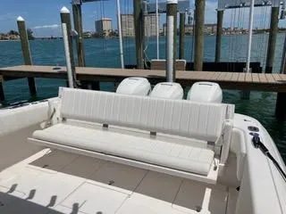 Slide: The Image of 2019 Intrepid 400 Center Console boat with white seating, docked by the water. - 10
