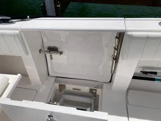 Slide: The Image of 2019 Intrepid 400 Center Console boat deck with storage compartment open. - 11