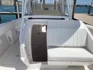 Slide: The Image of 2019 Intrepid 400 Center Console boat interior with white seating and open cabin door. - 5
