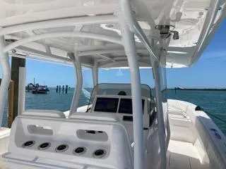Slide: The Image of 2019 Intrepid 400 Center Console boat with sleek design, docked by the water. - 7