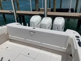 Slide: The Image of 2019 Intrepid 400 Center Console boat with triple outboard engines at dock. - 9