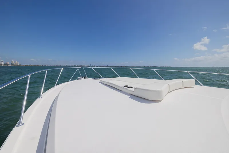Slide: The Image of 2022 Bertram 50 yacht deck with ocean view under clear blue sky. - 10