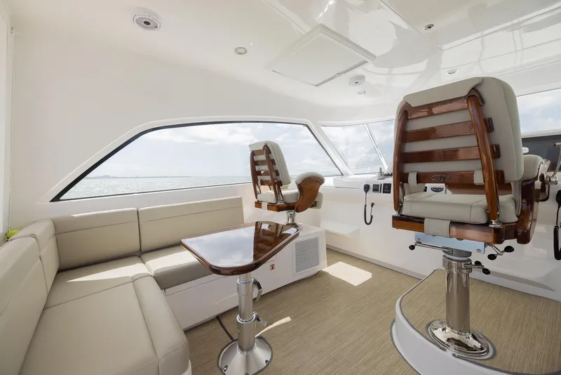 Slide: The Image of Luxurious interior of a 2022 Bertram 50 yacht with plush seating and modern helm chairs. - 17