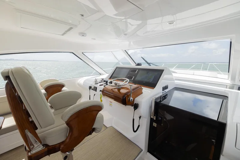Slide: The Image of Luxurious 2022 Bertram 50 yacht helm with modern controls and plush seating. - 18