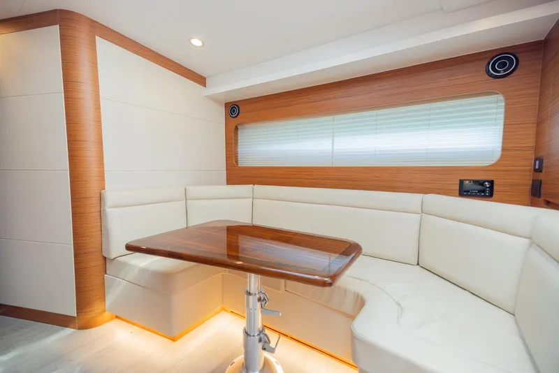 Slide: The Image of Luxurious interior of 2022 Bertram 50 yacht with elegant seating and wooden table. - 25