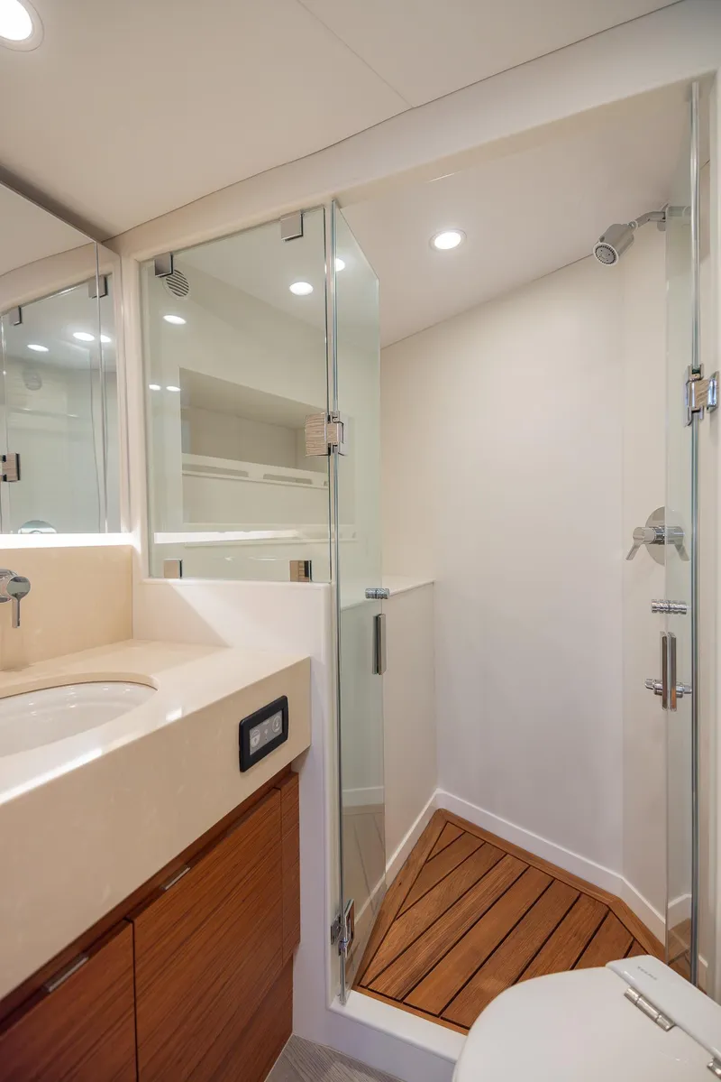 Slide: The Image of Modern bathroom in 2022 Bertram 50 yacht with glass shower and wooden accents. - 27