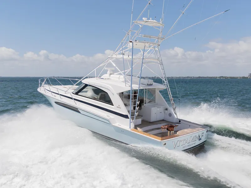 Slide: The Image of 2022 Bertram 50 yacht cruising on open water, showcasing sleek design and powerful performance. - 3