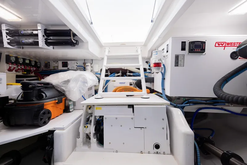 Slide: The Image of Engine room of a 2022 Bertram 50 yacht, featuring equipment and storage. - 30