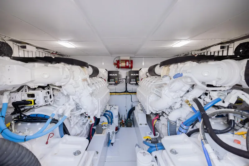 Slide: The Image of Engine room of a 2022 Bertram 50 yacht, featuring dual MAN engines. - 32