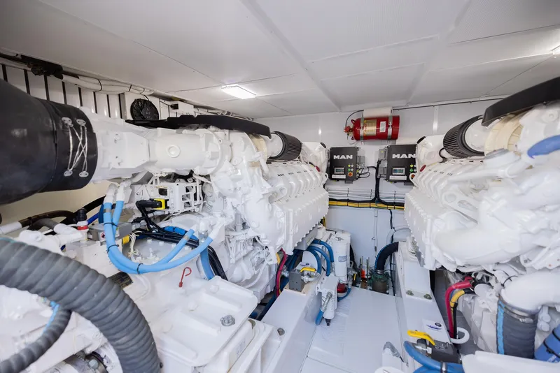 Slide: The Image of Engine room of a 2022 Bertram 50 yacht, featuring dual MAN engines. - 33