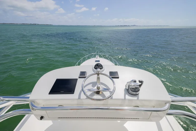 Slide: The Image of Helm of 2022 Bertram 50 yacht overlooking calm ocean waters. - 7