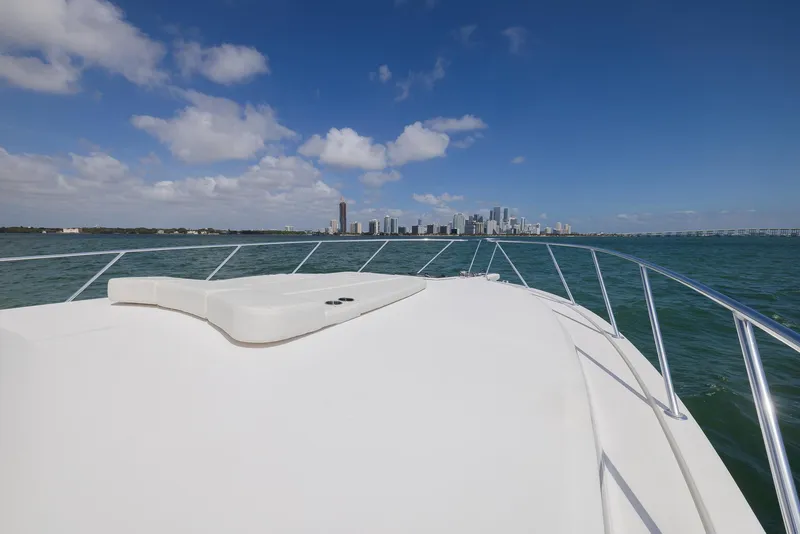 Slide: The Image of Bow view of 2022 Bertram 50 yacht approaching city skyline under blue sky. - 9
