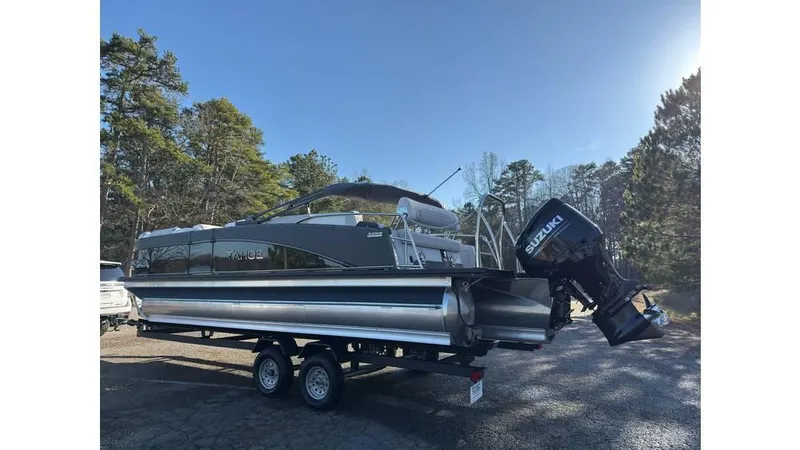 Slide: The Image of 2025 Tahoe Pontoon Cascade Cruise Rear Bench on trailer, parked outdoors. - 4