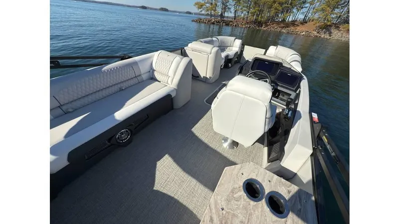 Slide: The Image of 2025 Tahoe Pontoon Cascade Cruise Rear Bench on serene lake with plush seating. - 5