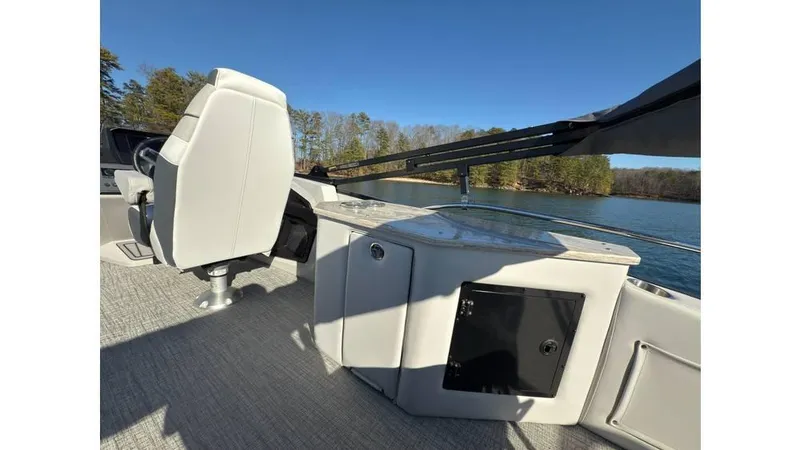 Slide: The Image of 2025 Tahoe Pontoon Cascade Cruise Rear Bench on a serene lake, showcasing sleek design and comfort. - 6