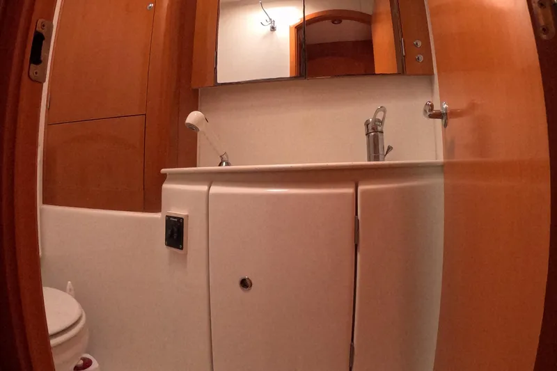 Slide: The Image of Bathroom interior of 2006 Lagoon 440 yacht with wooden cabinetry and modern fixtures. - 18