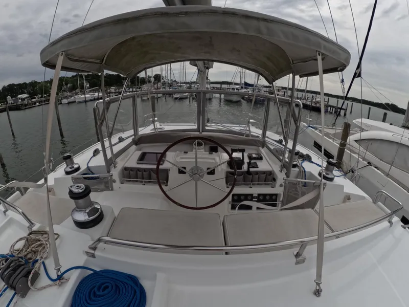 Slide: The Image of Lagoon 440 catamaran helm station with steering wheel, docked in a marina, 2006 model. - 25
