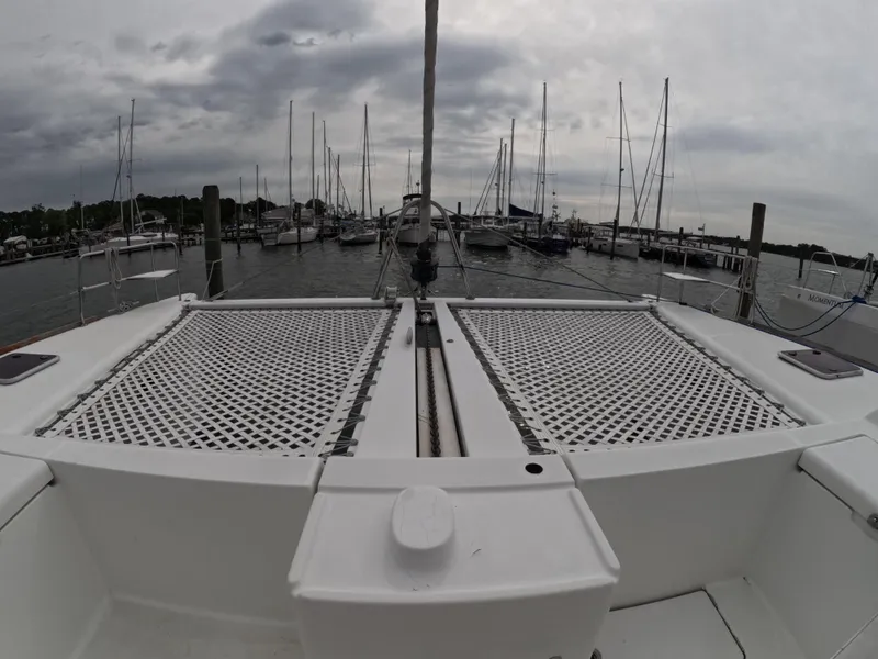 Slide: The Image of 2006 Lagoon 440 catamaran docked at marina with overcast sky. - 28