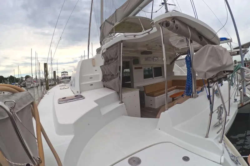 Slide: The Image of 2006 Lagoon 440 catamaran docked, showcasing spacious deck and seating area. - 31