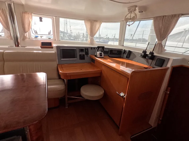 Slide: The Image of Interior of 2006 Lagoon 440 catamaran with navigation station and seating area. - 35
