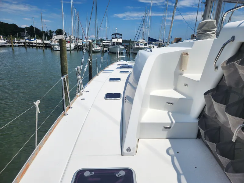 Slide: The Image of Lagoon 440 catamaran deck view, 2006 model, docked in a marina under clear skies. - 4