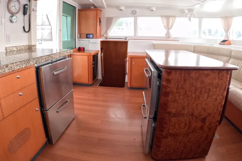 Slide: The Image of Interior of 2006 Lagoon 440 catamaran with modern kitchen and dining area. - 40