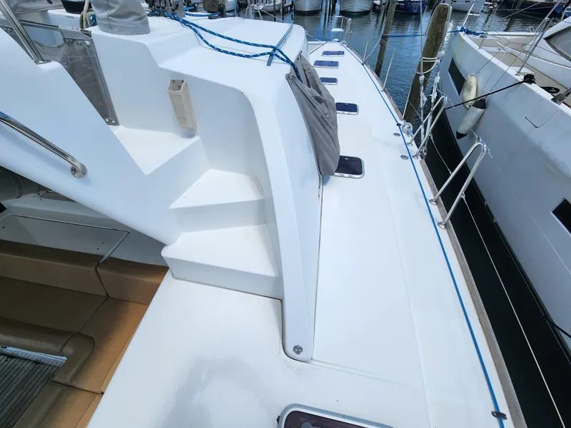 Slide: The Image of Deck view of 2006 Lagoon 440 catamaran, showcasing sleek design and mooring lines. - 6
