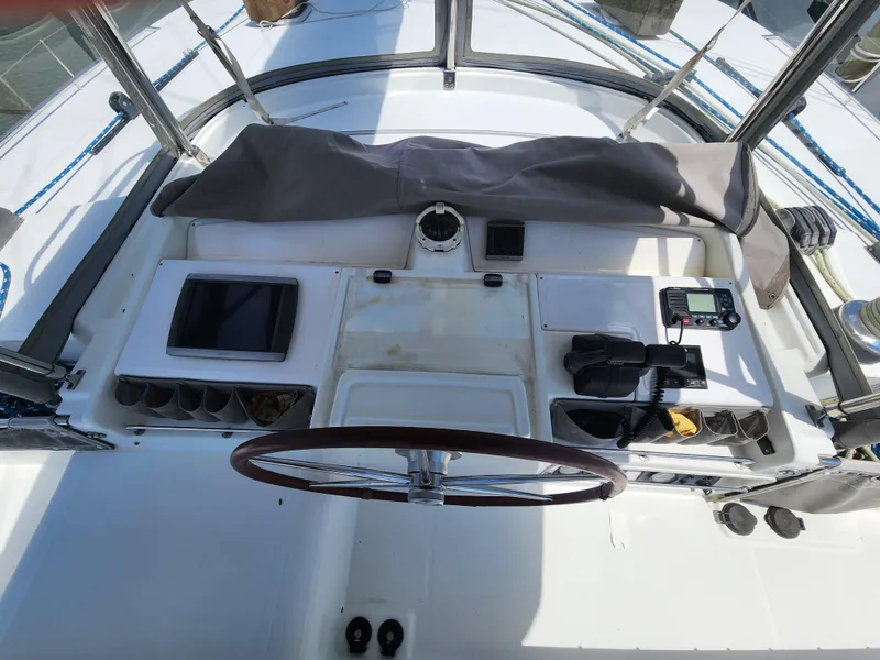 Slide: The Image of Helm station of 2006 Lagoon 440 catamaran with navigation equipment and steering wheel. - 7