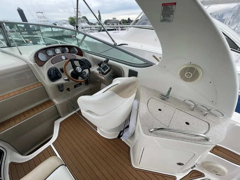 Slide: The Image of 2008 Sea Ray 280 Sundancer cockpit with helm, seating, and wet bar. - 10
