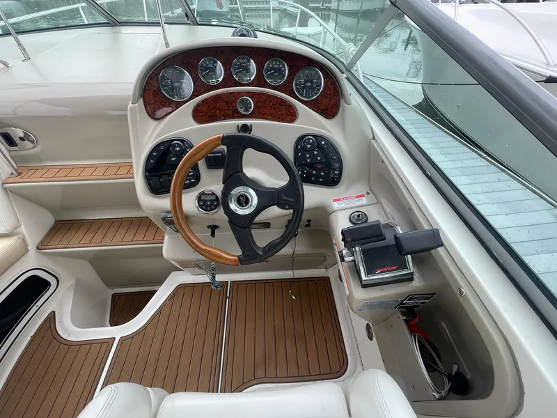 Slide: The Image of 2008 Sea Ray 280 Sundancer helm with wood accents and modern controls. - 12