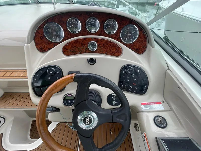 Slide: The Image of 2008 Sea Ray 280 Sundancer dashboard with wood accents and steering wheel. - 13