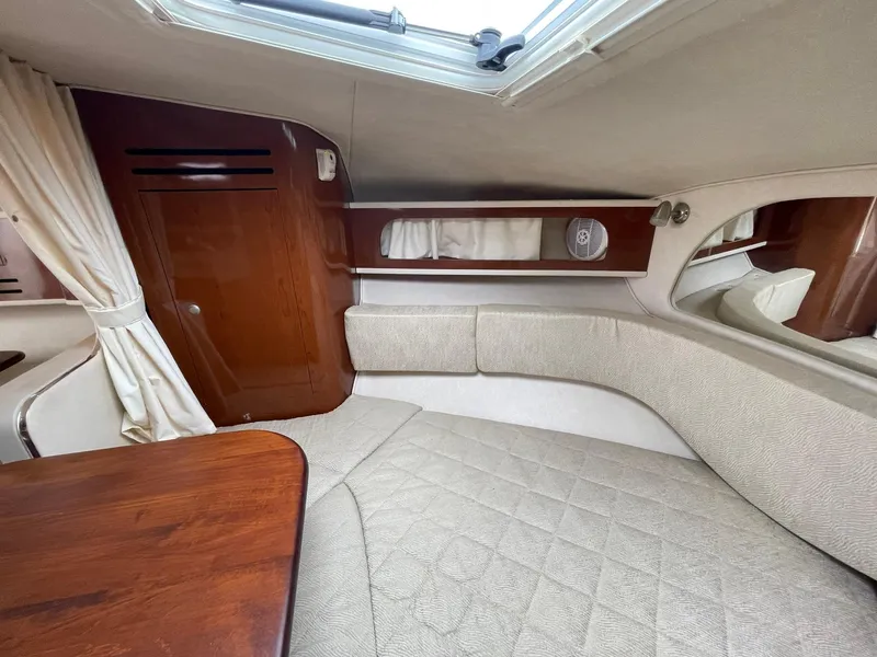Slide: The Image of Interior of 2008 Sea Ray 280 Sundancer, featuring cozy seating and elegant wood finishes. - 16