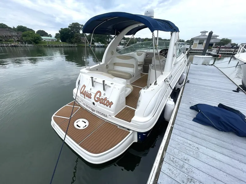 Slide: The Image of 2008 Sea Ray 280 Sundancer docked, featuring a spacious deck and blue canopy. - 2