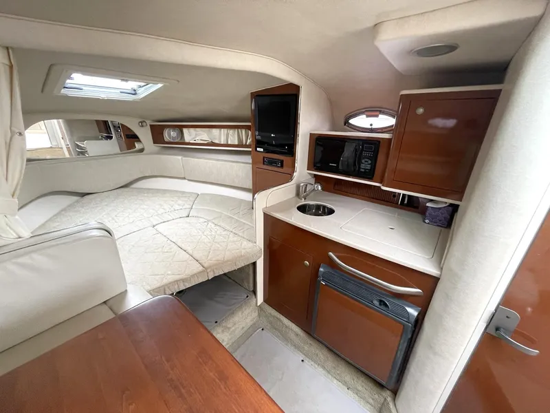 Slide: The Image of Interior of 2008 Sea Ray 280 Sundancer with kitchenette, bed, and seating area. - 20