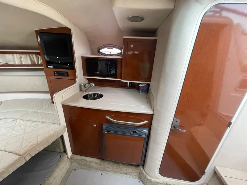 Slide: The Image of 2008 Sea Ray 280 Sundancer cabin interior with kitchenette and seating area. - 21