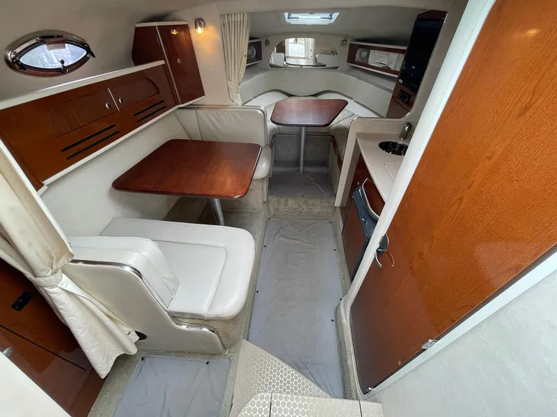 Slide: The Image of 2008 Sea Ray 280 Sundancer cabin interior with dining area and kitchenette. - 25