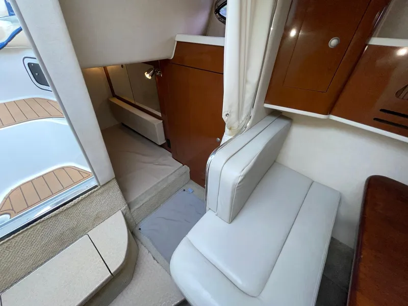 Slide: The Image of Interior of 2008 Sea Ray 280 Sundancer, featuring seating and wooden cabinetry. - 27