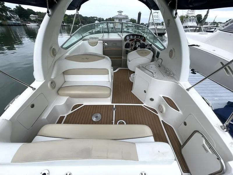 Slide: The Image of 2008 Sea Ray 280 Sundancer boat interior with beige seating and wood flooring. - 3