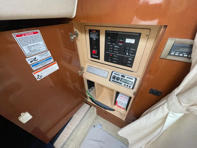 Slide: The Image of Control panel inside 2008 Sea Ray 280 Sundancer boat, featuring various switches and gauges. - 32