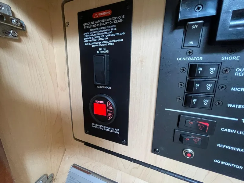 Slide: The Image of Control panel of a 2008 Sea Ray 280 Sundancer boat, featuring generator and bilge blower switches. - 34