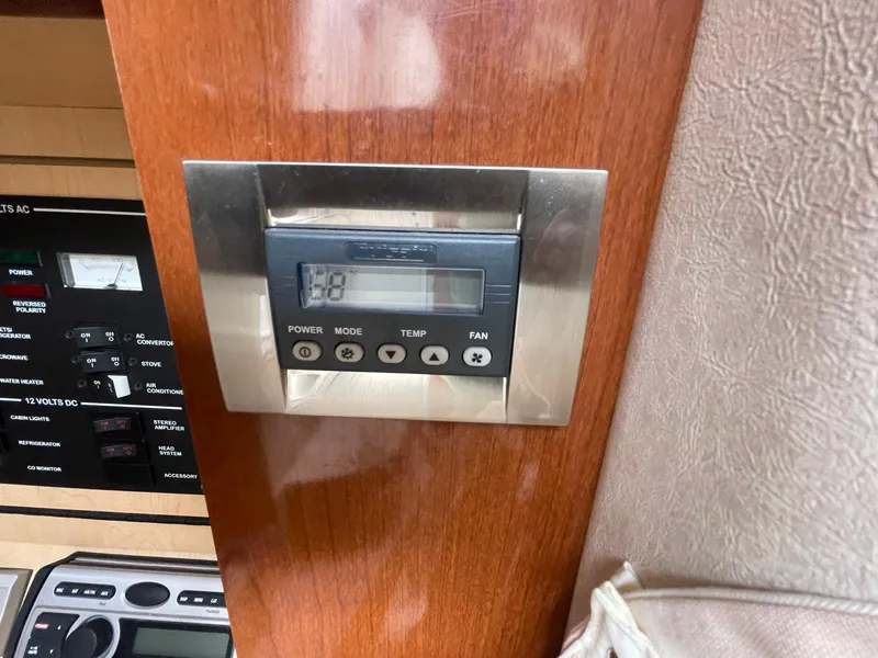 Slide: The Image of Control panel on 2008 Sea Ray 280 Sundancer boat, featuring temperature and fan settings. - 35